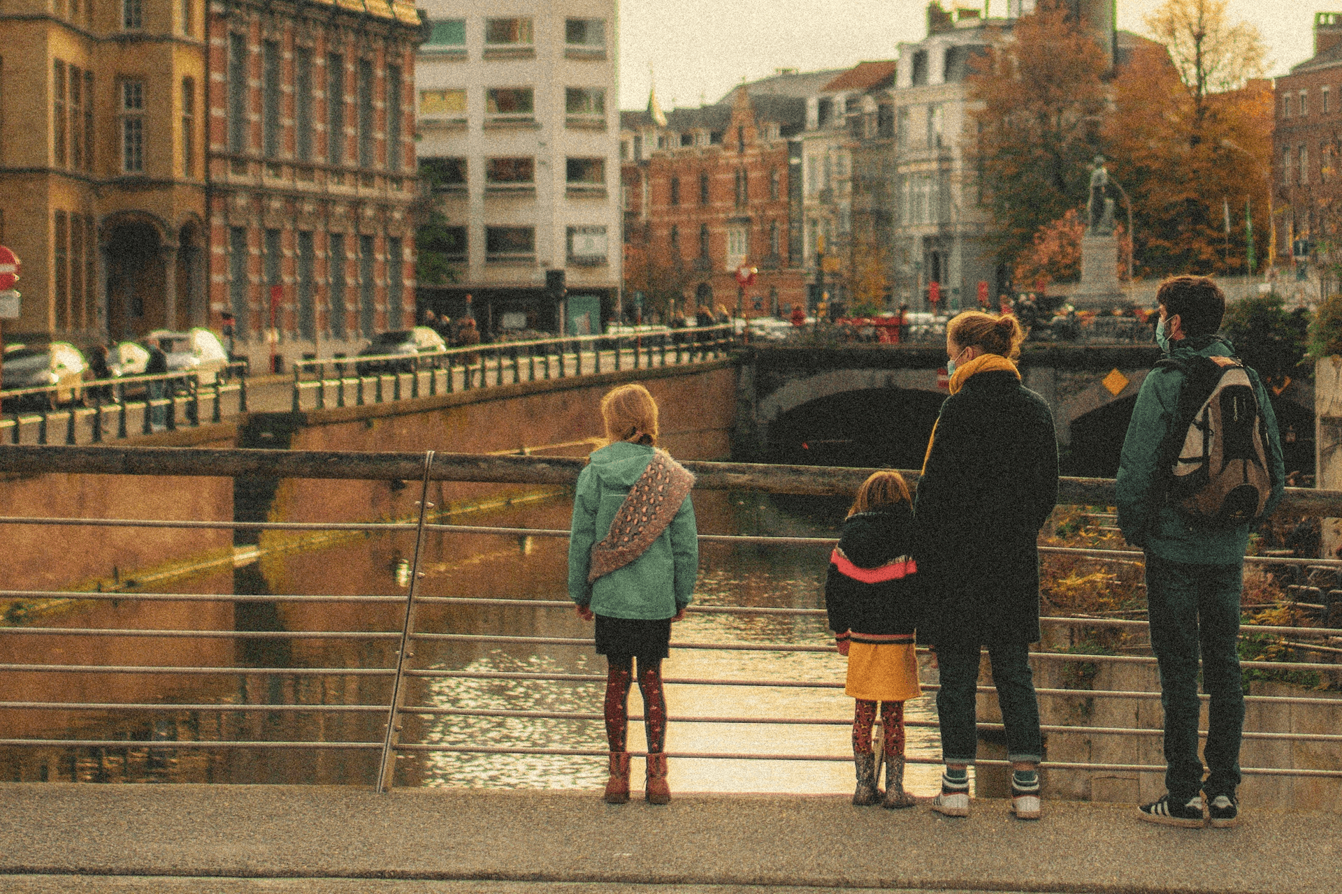 Family strolling beside a calm canal in a Nordic city — simple, urban everyday travel.