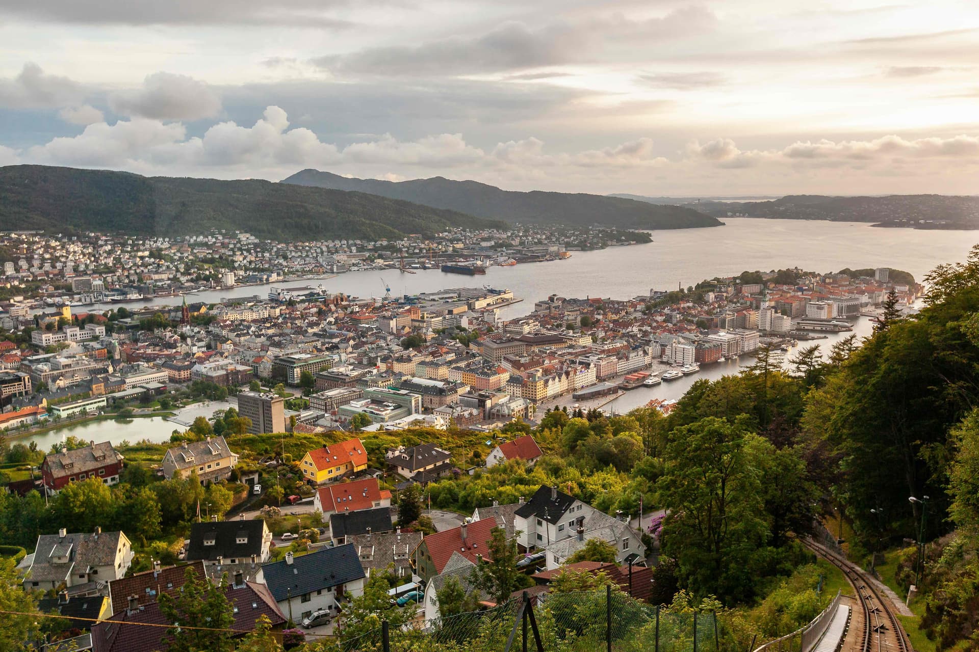 Mount Fløyen viewpoint overlooking Bergen city and harbor, with the Fløibanen funicular below.