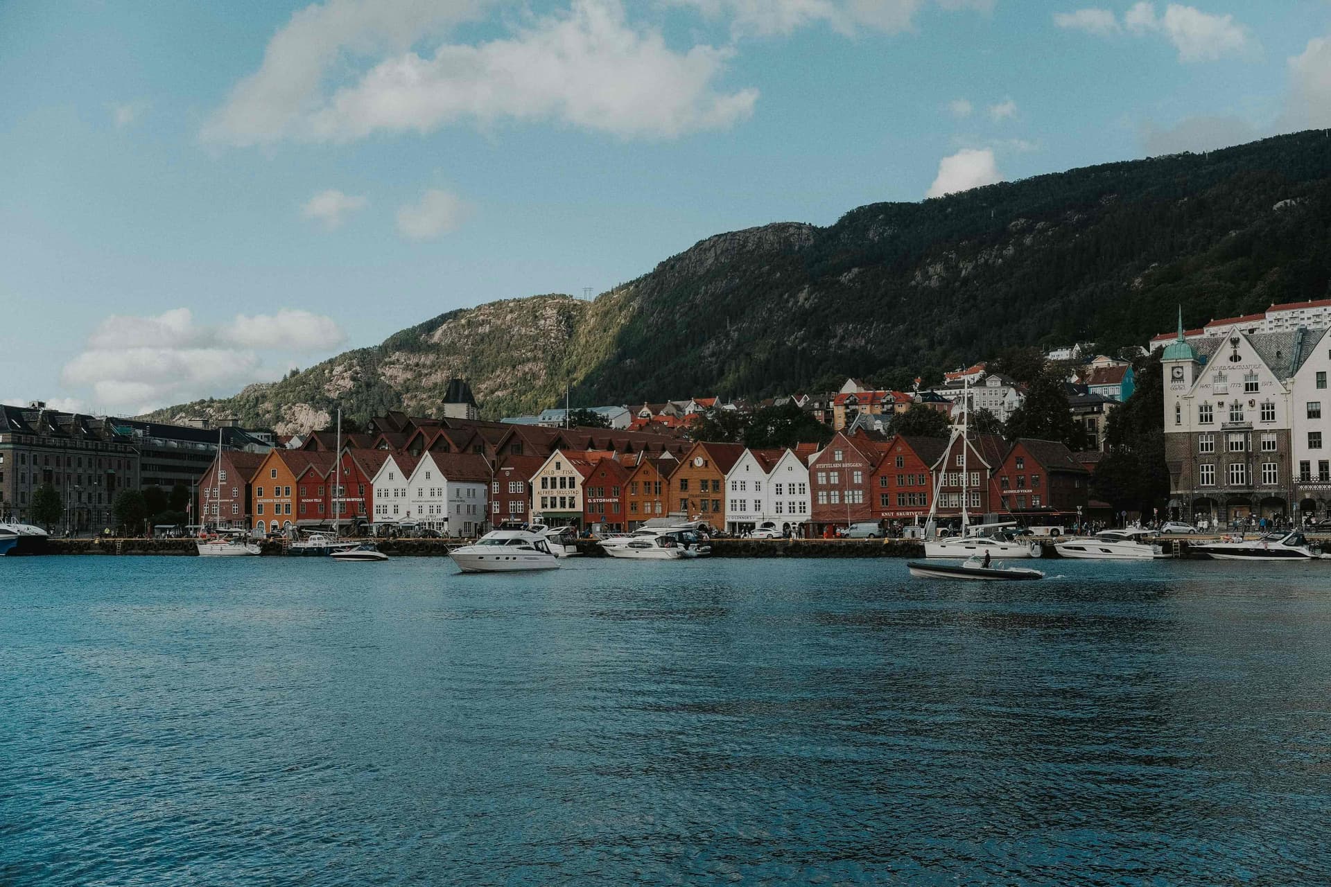 Winter morning over Bergen harbor with Bryggen’s colorful wooden houses and boats.